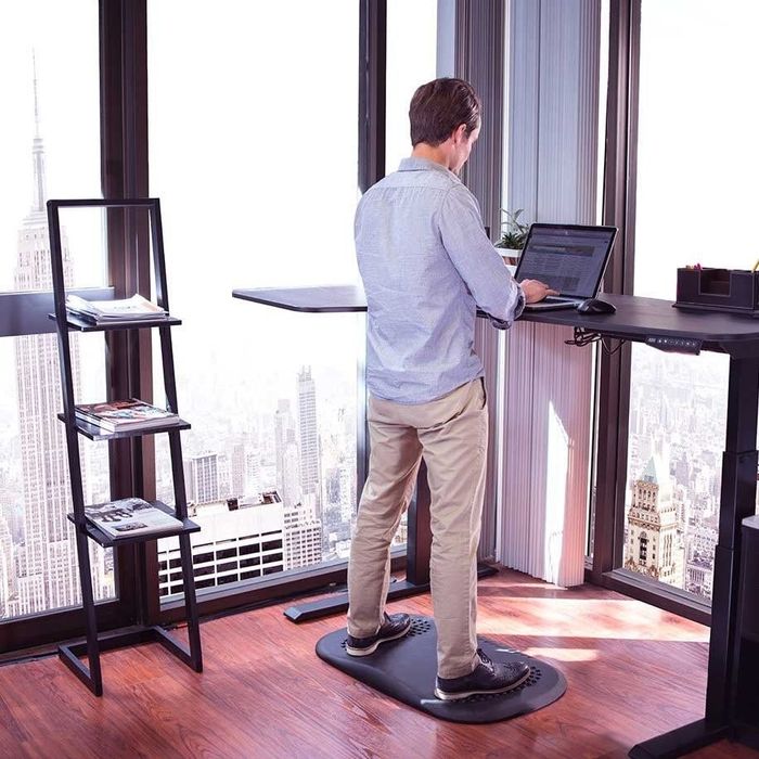 Model standing on the mat at a computer, showcasing its comfort and support.