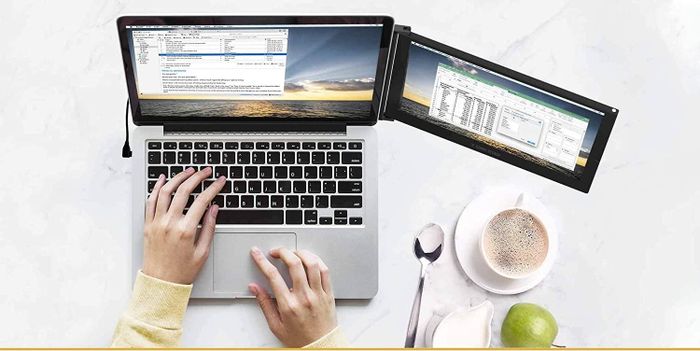 A laptop with a small external monitor attached alongside the main one