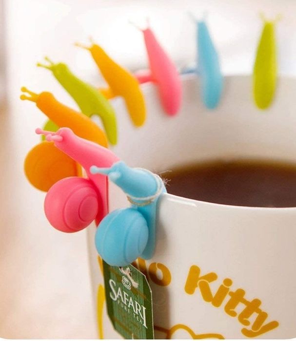 A tea mug with snail-shaped holders on the rim to conveniently tie your teabag string around.