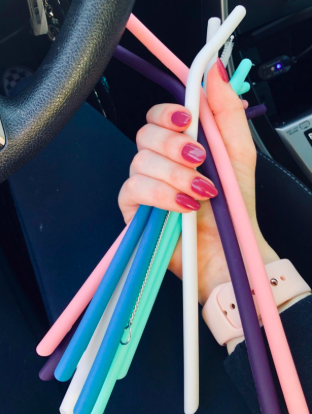a hand holding a set of the silicone straws