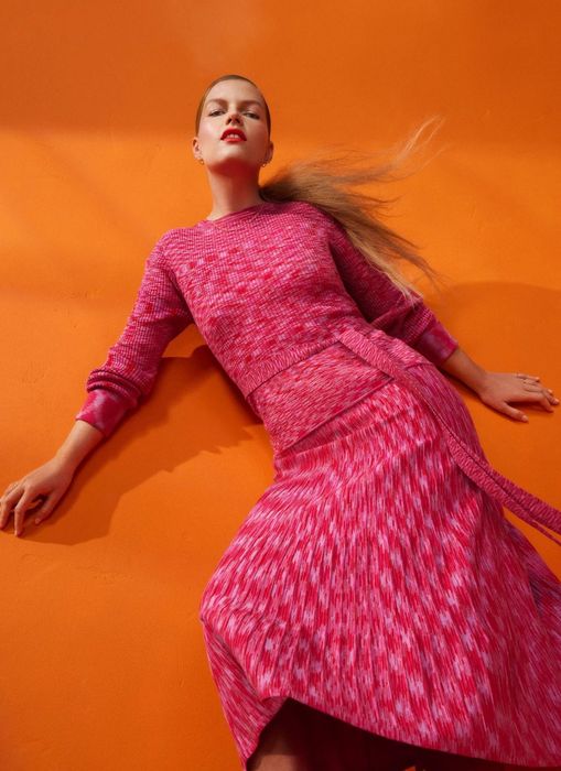 Model rocking a magenta-colored long-sleeve midi dress.