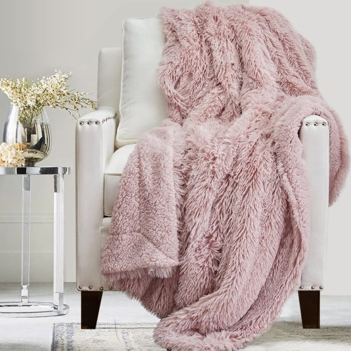 The dusty rose blanket draped elegantly over a chair