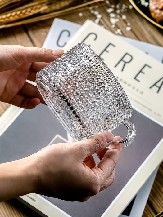 A model holding one of the elegant glasses.