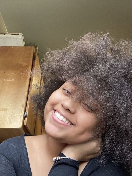 A reviewer proudly displaying her defined curls