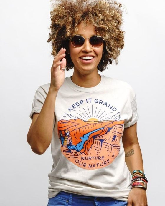 A person wearing a Grand Canyon shirt that reads 'Keep it grand; nurture our nature.'