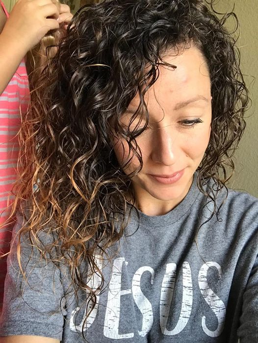 Image of a reviewer flaunting vibrant, shiny curls