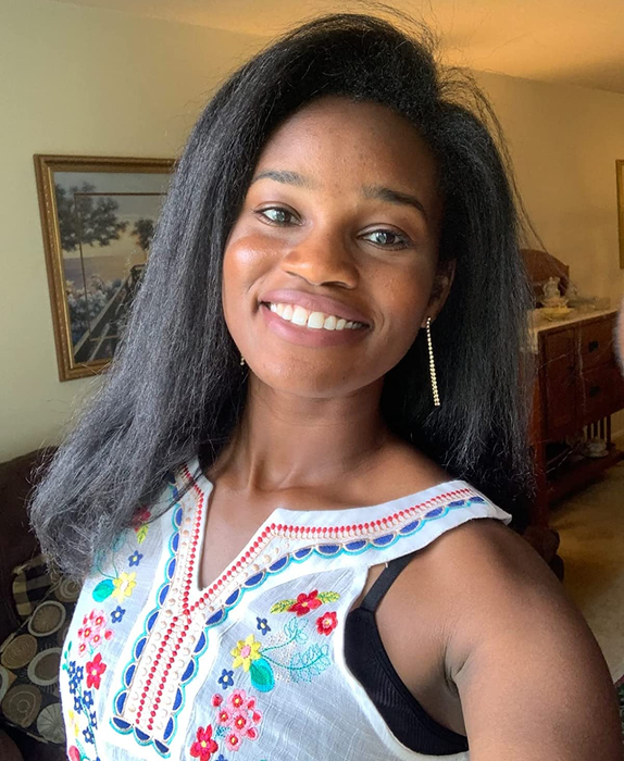 A photo of the same reviewer with their hair straightened using the Revlon One-Step Paddle Brush