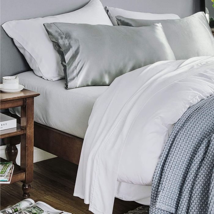 Gray satin pillows placed on a bed