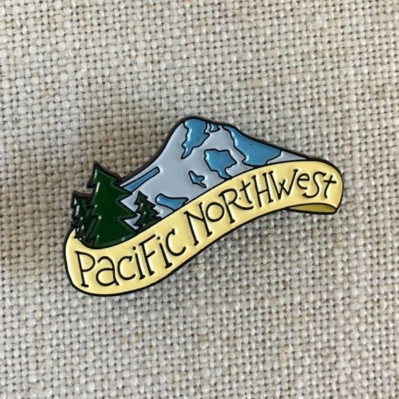 A pin featuring a mountain range and evergreen trees, proudly displaying the words 'Pacific Northwest'.