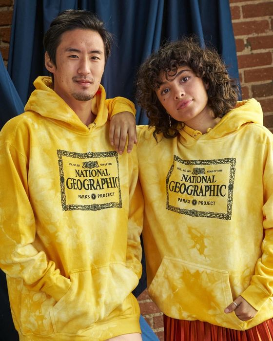 two models in yellow tie-dye hoodies with the National Geographic logo