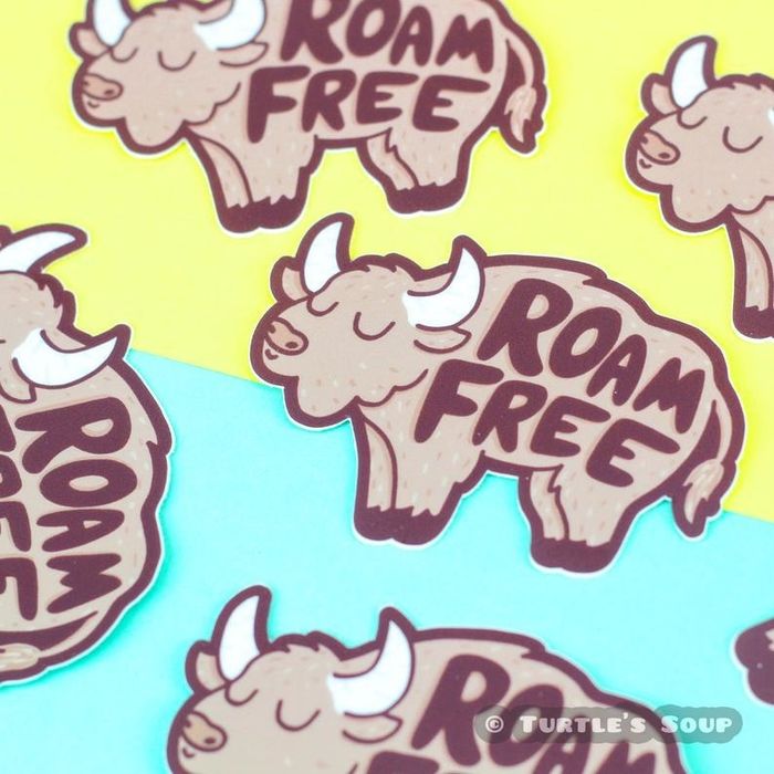 A buffalo-shaped sticker that reads 'roam free'.
