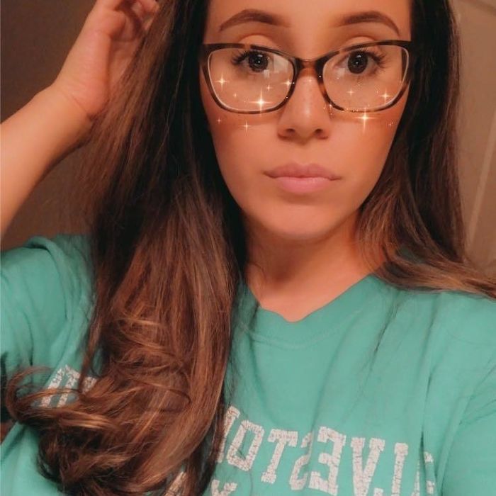 The same reviewer with their hair styled straight using the hot-air brush