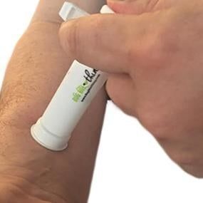 person using the tool on their arm to relieve a bite