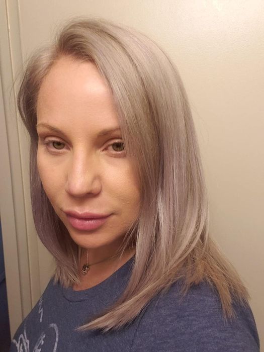 A picture of a reviewer with healthy, smooth, straight blonde hair