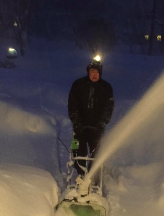 A reviewer's photo showing someone operating a snow thrower.