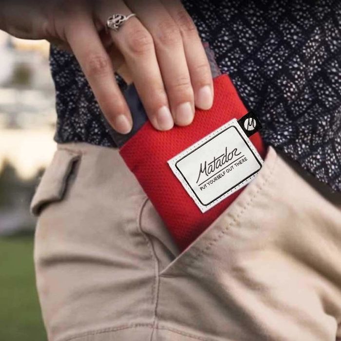 A blanket neatly folded into a compact pouch, making it easy to carry wherever you go.