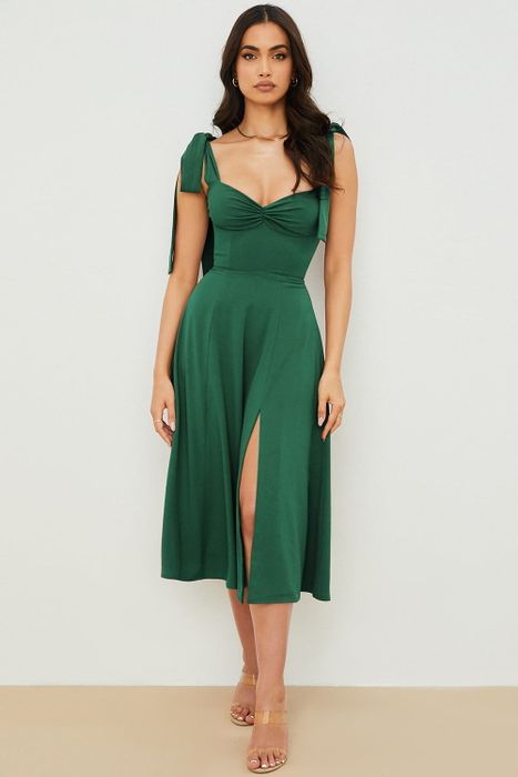 A model showcasing the emerald green dress