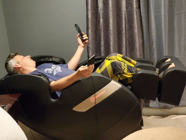 A reviewer enjoys total relaxation while reclining in the chair.