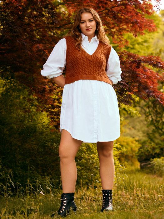 A model wearing a white shirt dress with a brown vest and black combat boots