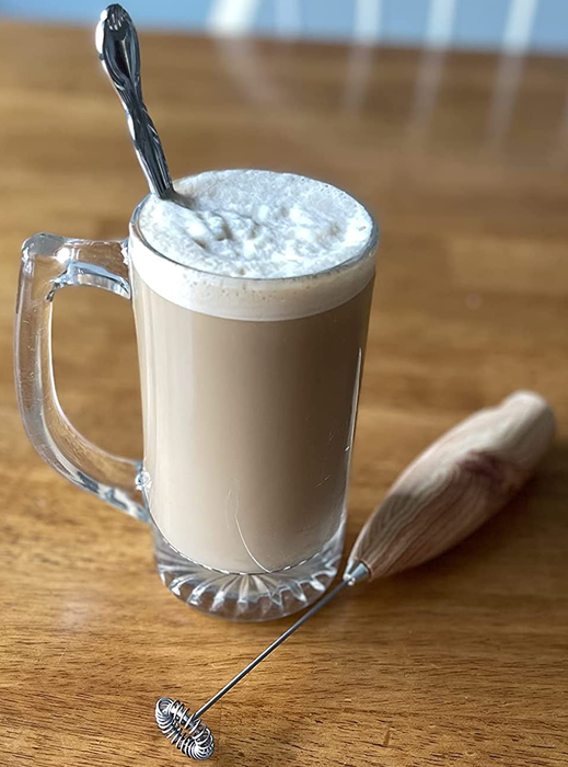 Another reviewer’s foamy drink sitting next to the milk frother.