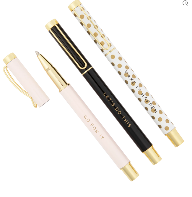 A set of three pens in pastel pink, black, and white with gold accents and motivational quotes on each one, featuring polka dots and gold details.