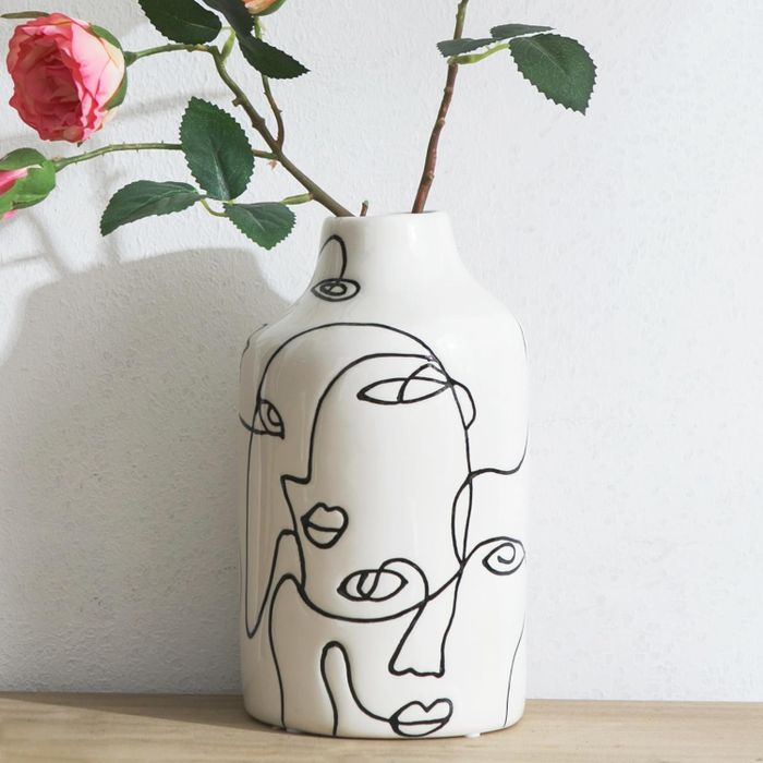 A close-up view of the same vase, now showcasing vibrant flowers.