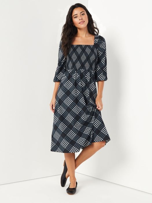 A model wearing the black and white plaid dress