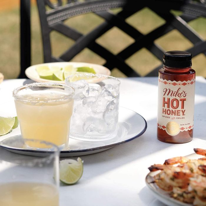 A bottle of honey placed elegantly on a table.