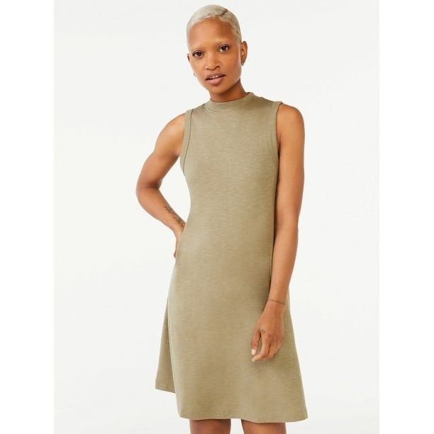 A model showcasing the beige version of the dress
