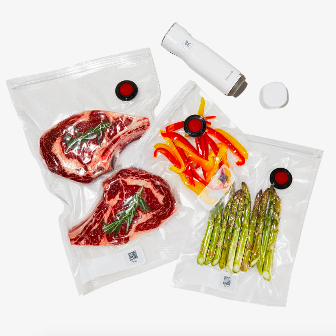 Sliced meat, peppers, and asparagus neatly packed in vacuum-sealed bags.
