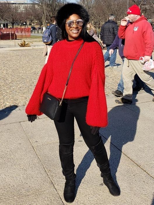 Reviewer wearing the sweater in a vibrant red color