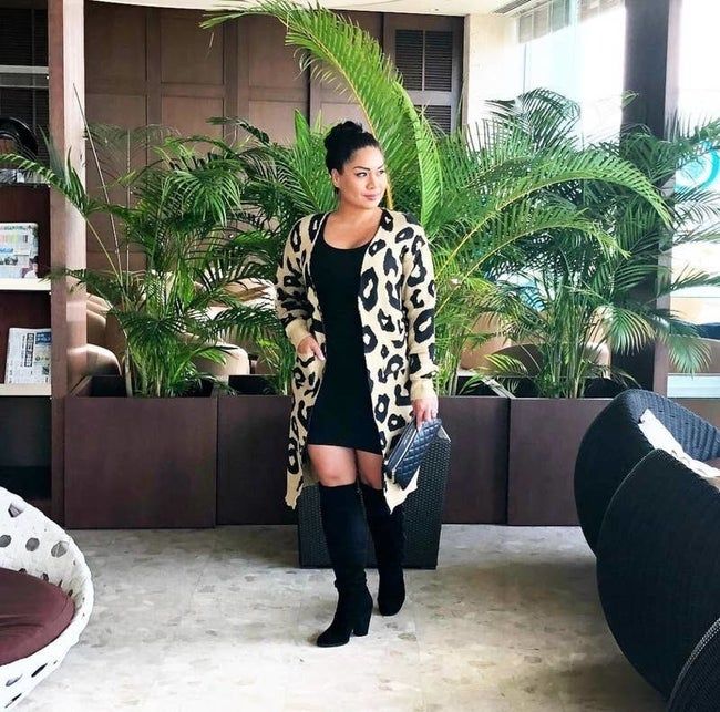 Reviewer wearing an open-front cardigan in light brown with black leopard print