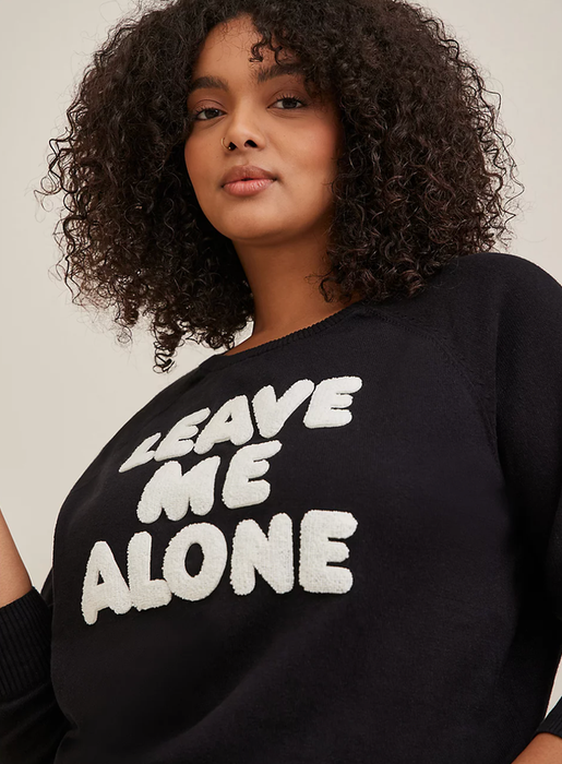 Model wearing a 'leave me alone' graphic sweater