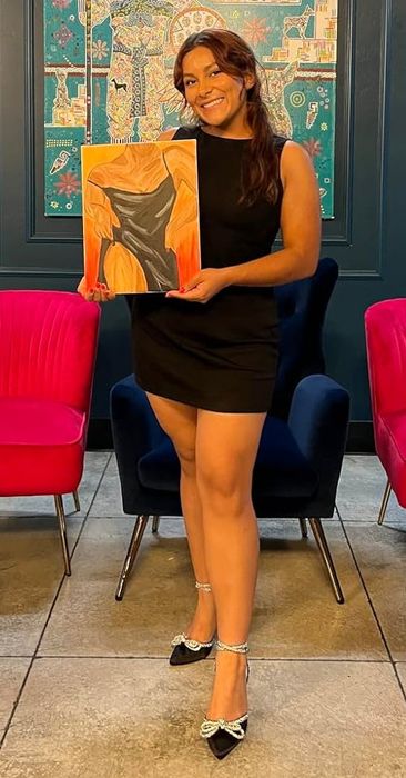 The reviewer is seen wearing a black dress.