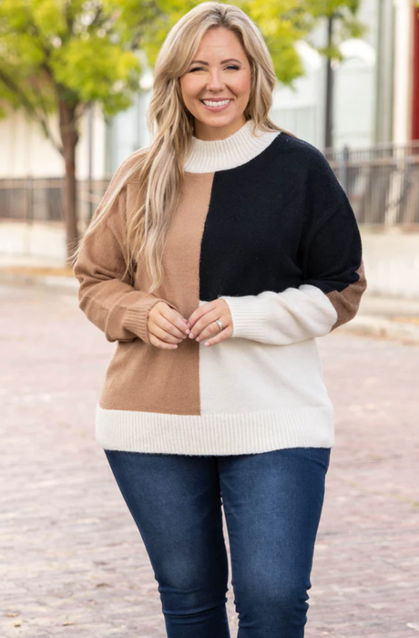 Model wearing a 'Not Without You' sweater in taupe, paired with jeans