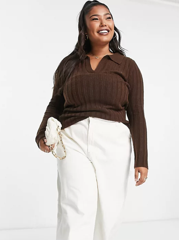 Same model wearing the sweater with white pants