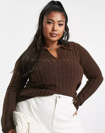 Model wearing a collared sweater paired with white pants