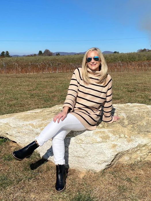 A reviewer sporting the striped toffee sweater.
