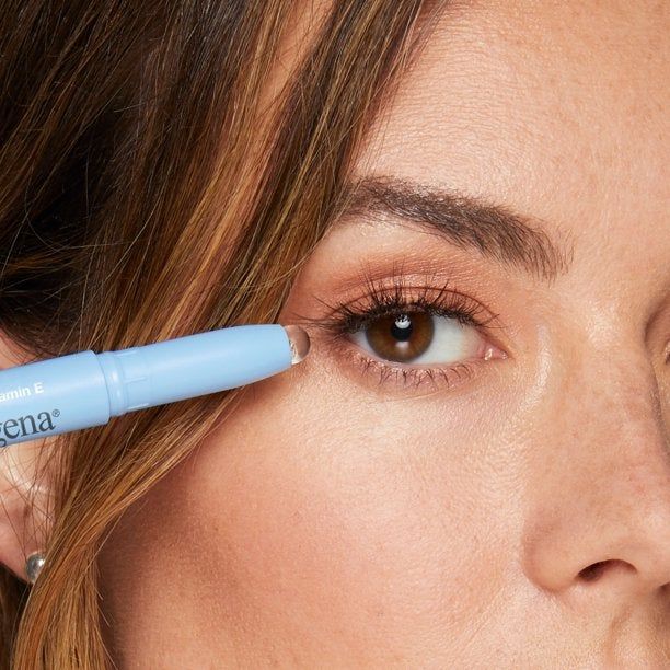 A model demonstrating the use of the gel eraser stick near their eye.