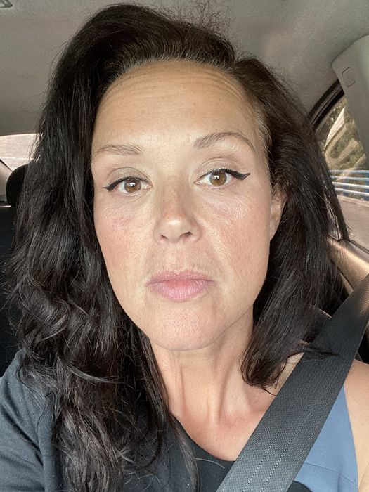 A reviewer showcasing a champagne-toned eyeshadow applied to their eyelids.