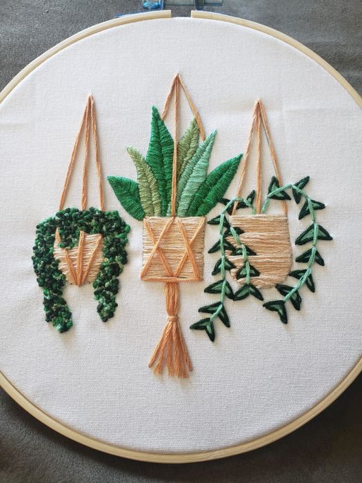 A set of three embroidered plants in a hoop.