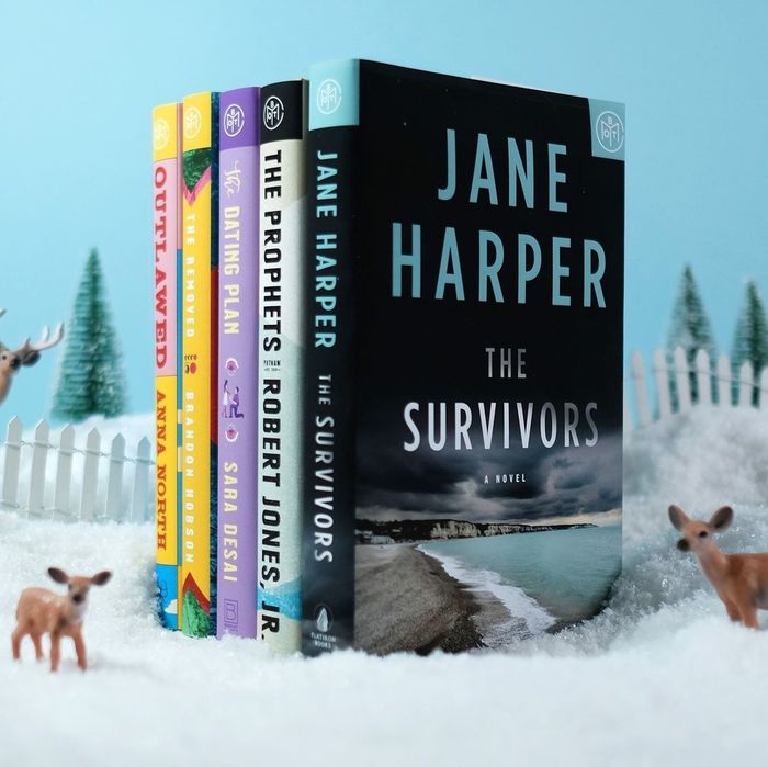 Five books stacked next to each other, surrounded by a snowy scene