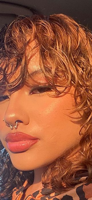 A closeup of a reviewer's face showcasing a flawless makeup application, thanks to the powder puff.