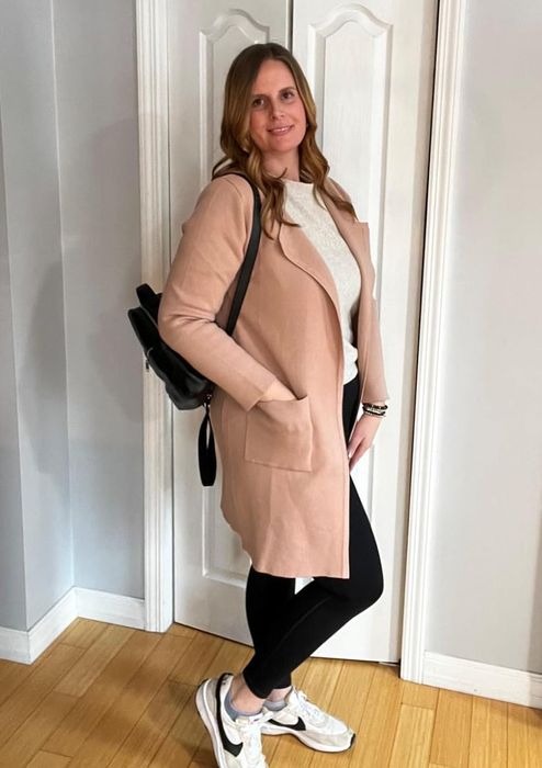 The reviewer is wearing a khaki coatigan.