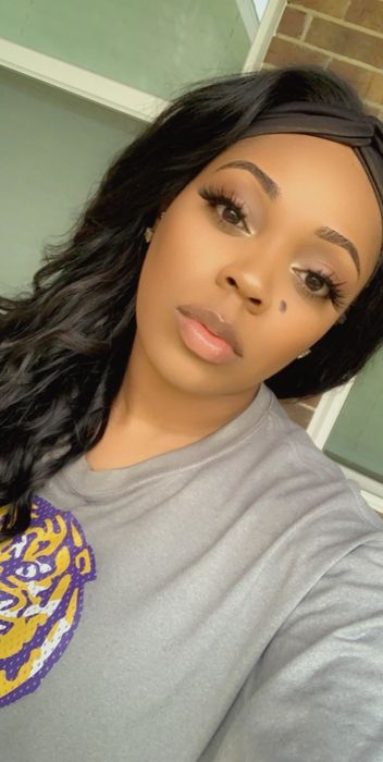 A reviewer with a deeper skin tone using a matte blush for contouring