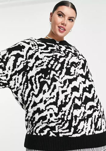 A model is wearing the cream animal jacquard sweater.