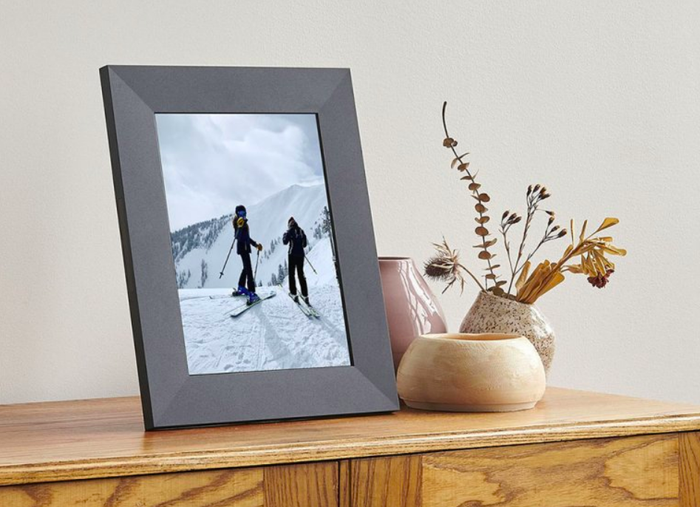 A desk-mounted picture frame displaying a photo, capturing a moment in time.
