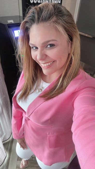 Reviewer dressed in the pink blazer