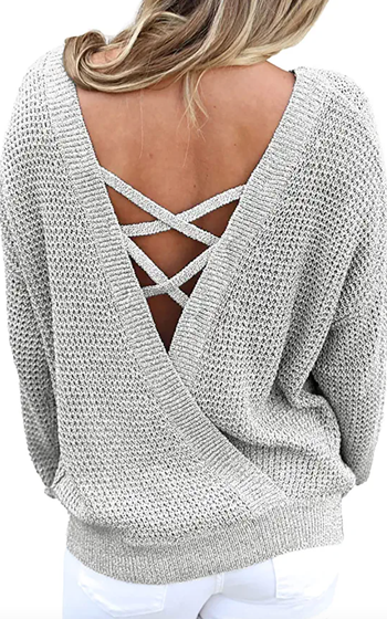 Model showcasing a light grey sweater with a crisscross back design