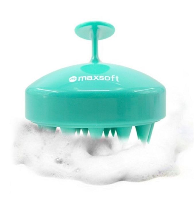 A green-colored brush designed to massage the scalp.